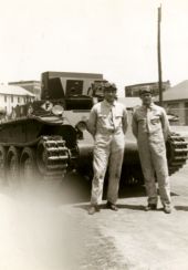 Jay L. Hall and Henry W. McMillan from Company M, 124th Infantry standing in front of a tank at Ft. Benning, Georgia.