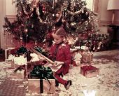Governor's stepdaughter Adriana Dolabella by the tree in the mansion with Christmas presents.