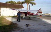 Dale McDonald with Jake Roberson's airplane at the Key West Airport in preparation for a photo flight..
