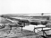 Unidentified men by a canal .
