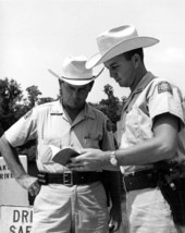 Game and fish officers look over a pamphlet