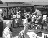 Officer James "Jim" Barkuloo measures Largemouth Black Bass while others wait - Leon County, Florida.