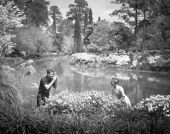 Woman posing for photographer among flowers at the Killearn Gardens State Park - Tallahassee, Florida.