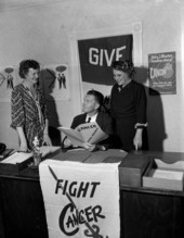Campaign chairman Joe Walsh from the Duval County Chapter of the American Cancer Society looking at book with unidentified women - Jacksonville, Florida