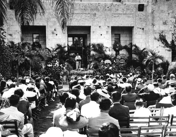 Mourners listen to a speaker at Carl G. Fisher's funeral